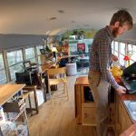 school bus tiny house interior view with owner