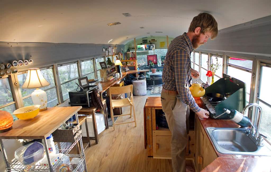 Image of: school bus tiny house interior view with owner